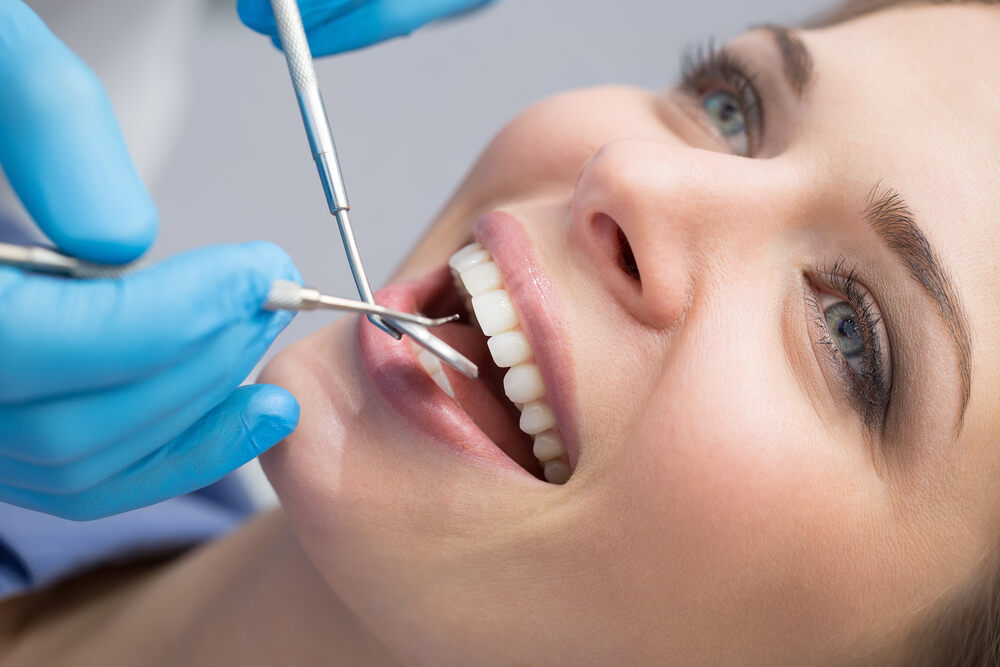 a woman is getting dental treatment