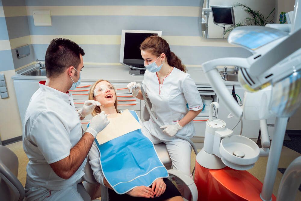 dentists are performing dental bridge treatment