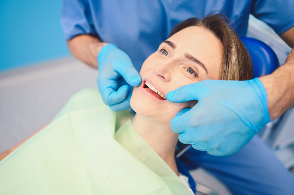 our dentist is treating dental gaps with a dental bonding